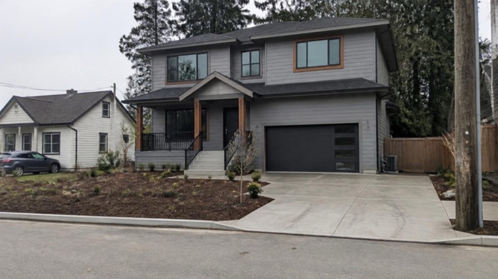 Newly finished two-storey family home with a concrete driveway and front steps
